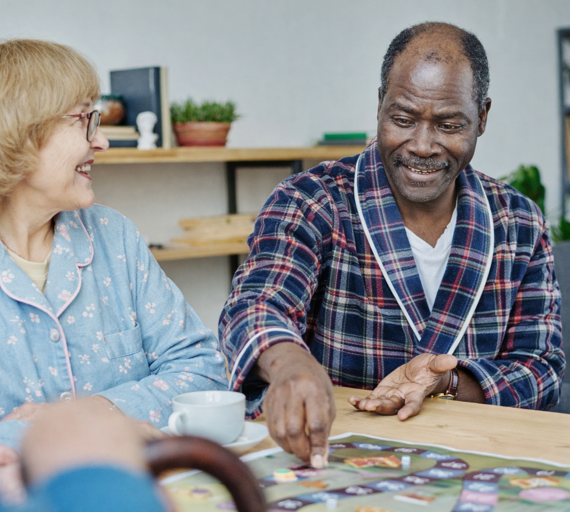 Compassionate caregiver sitting with senior resident